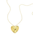 Goudkleurige lange stainless steel ketting met groot stralend hart en klein hartje in het midden