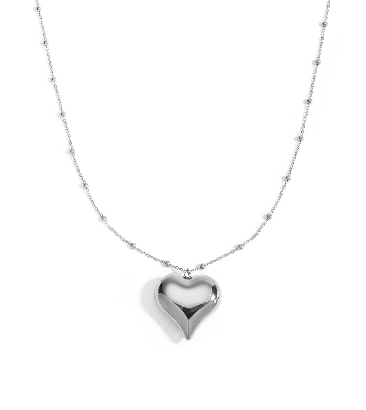 Lange zilverkleurige stainless steel ketting met kleine bolletjes en bolle hartjeshanger